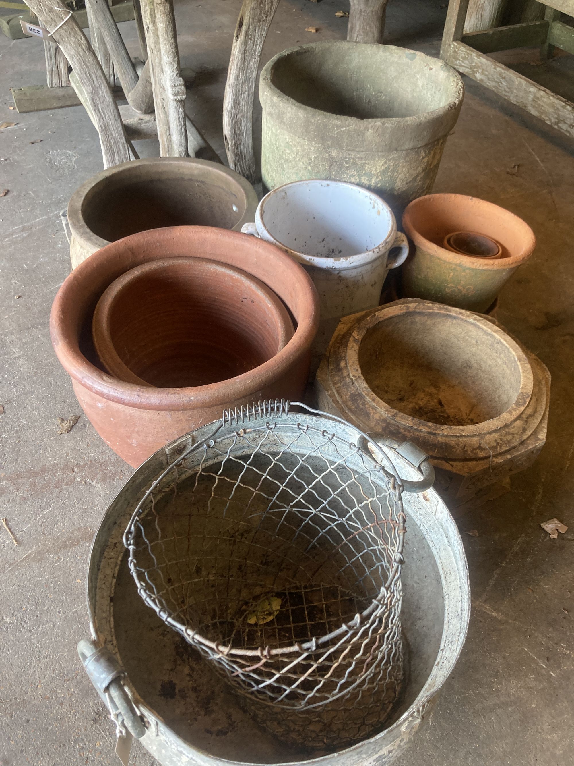 A quantity of assorted terracotta, glazed earthenware and metal garden planters together with a wirework basket, largest 40cm diameter